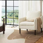 Fauteuil d'appoint rembourré avec accoudoirs incurvés et assise à ressorts ensachés